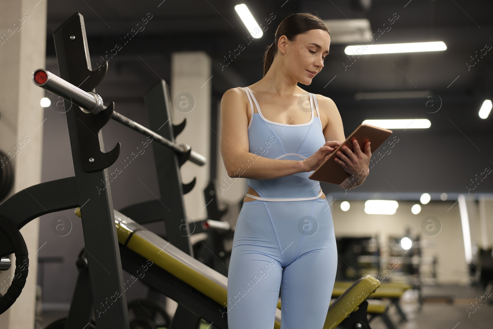 Photo of Professional personal trainer with tablet in gym