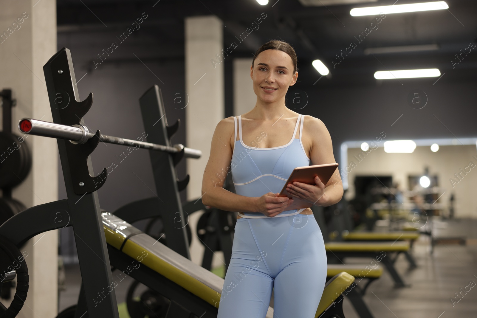Photo of Professional personal trainer with tablet in gym