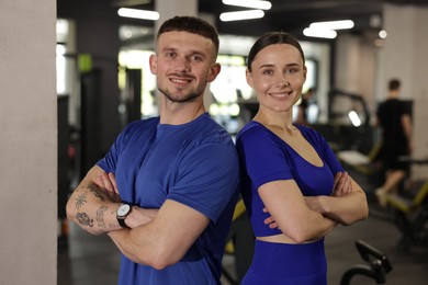 Photo of Portrait of professional personal trainers in gym