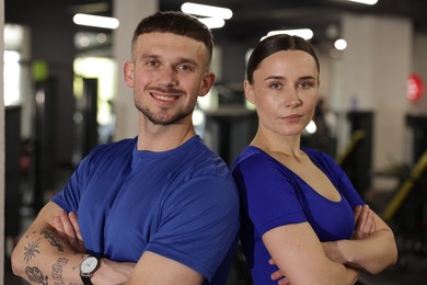 Photo of Portrait of professional personal trainers in gym