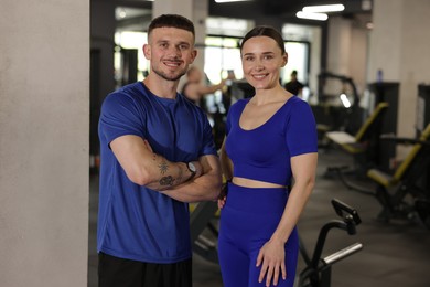 Photo of Portrait of professional personal trainers in gym