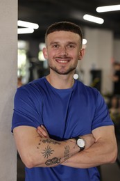 Photo of Portrait of professional personal trainer in gym