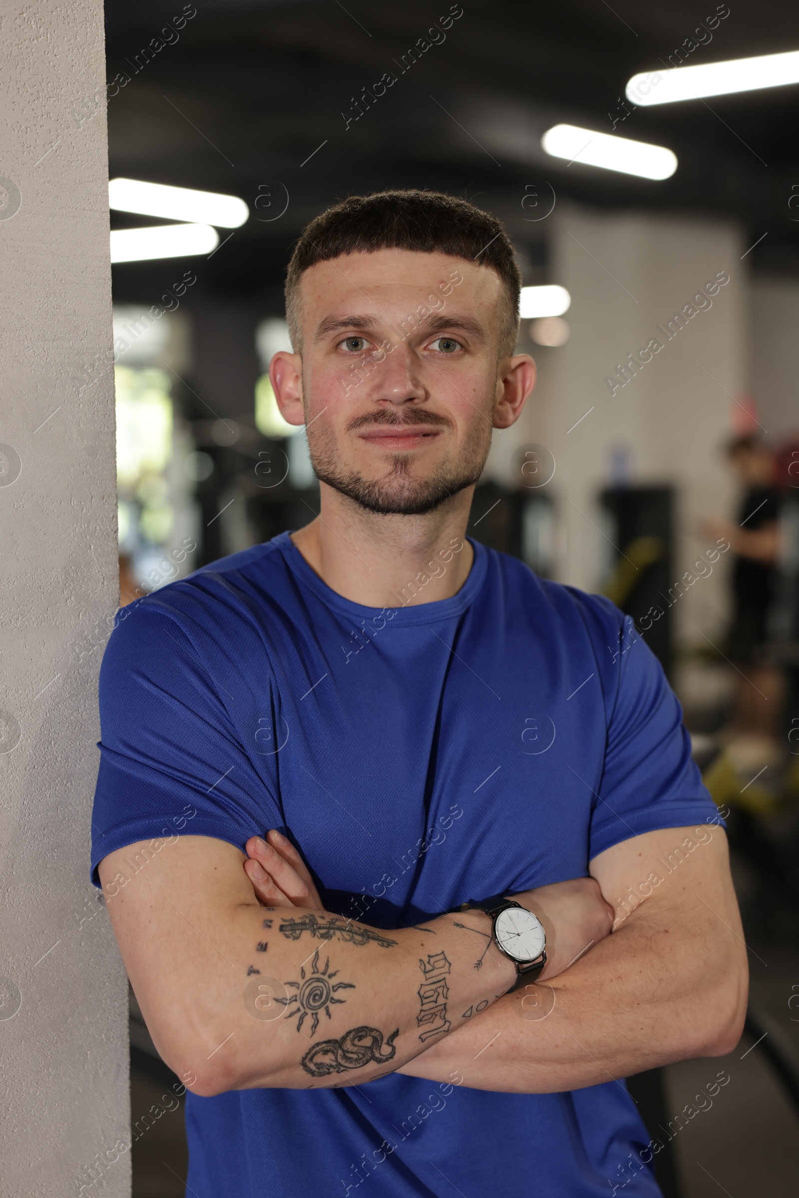 Photo of Portrait of professional personal trainer in gym