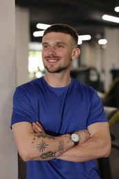Photo of Portrait of professional personal trainer in gym