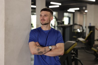Photo of Portrait of professional personal trainer in gym