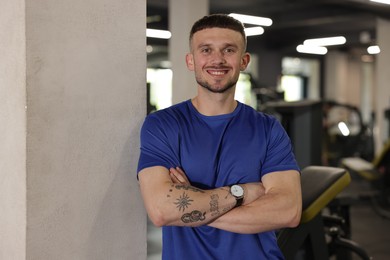 Photo of Portrait of professional personal trainer in gym