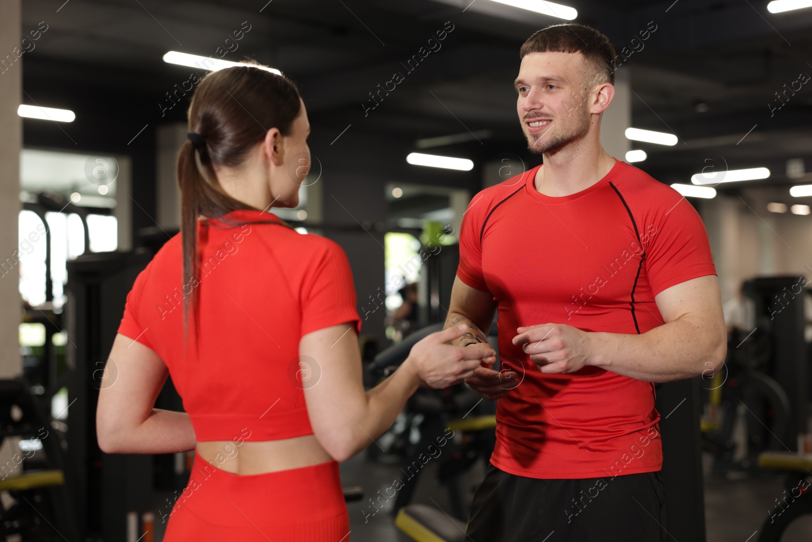 Professional personal trainers talking in sport center Photo of Professional personal trainers talking in sport center