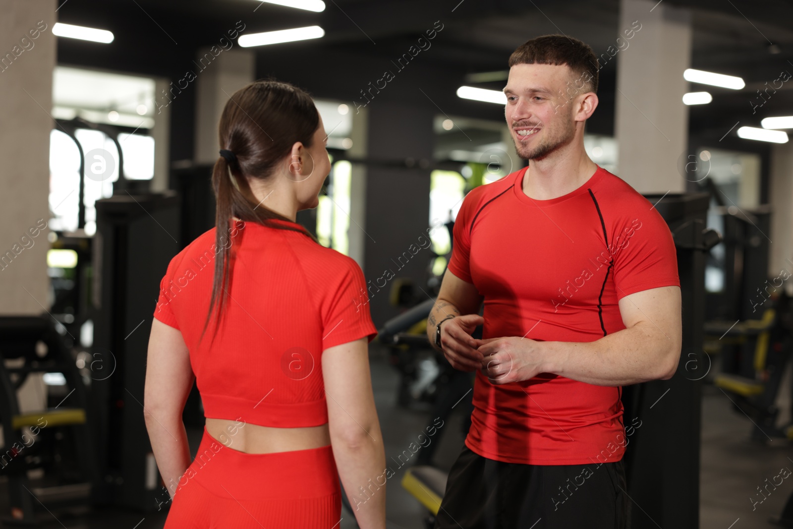 Professional personal trainers talking in sport center Photo of Professional personal trainers talking in sport center