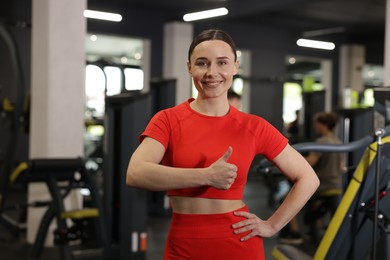 Photo of Personal trainer showing thumbs up in gym