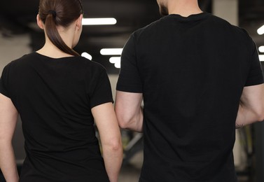 Photo of Personal trainers in sport center, back view