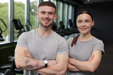 Photo of Portrait of personal trainers in sport center