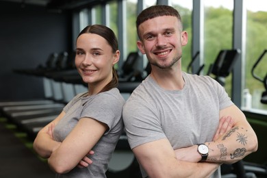 Photo of Portrait of personal trainers in sport center