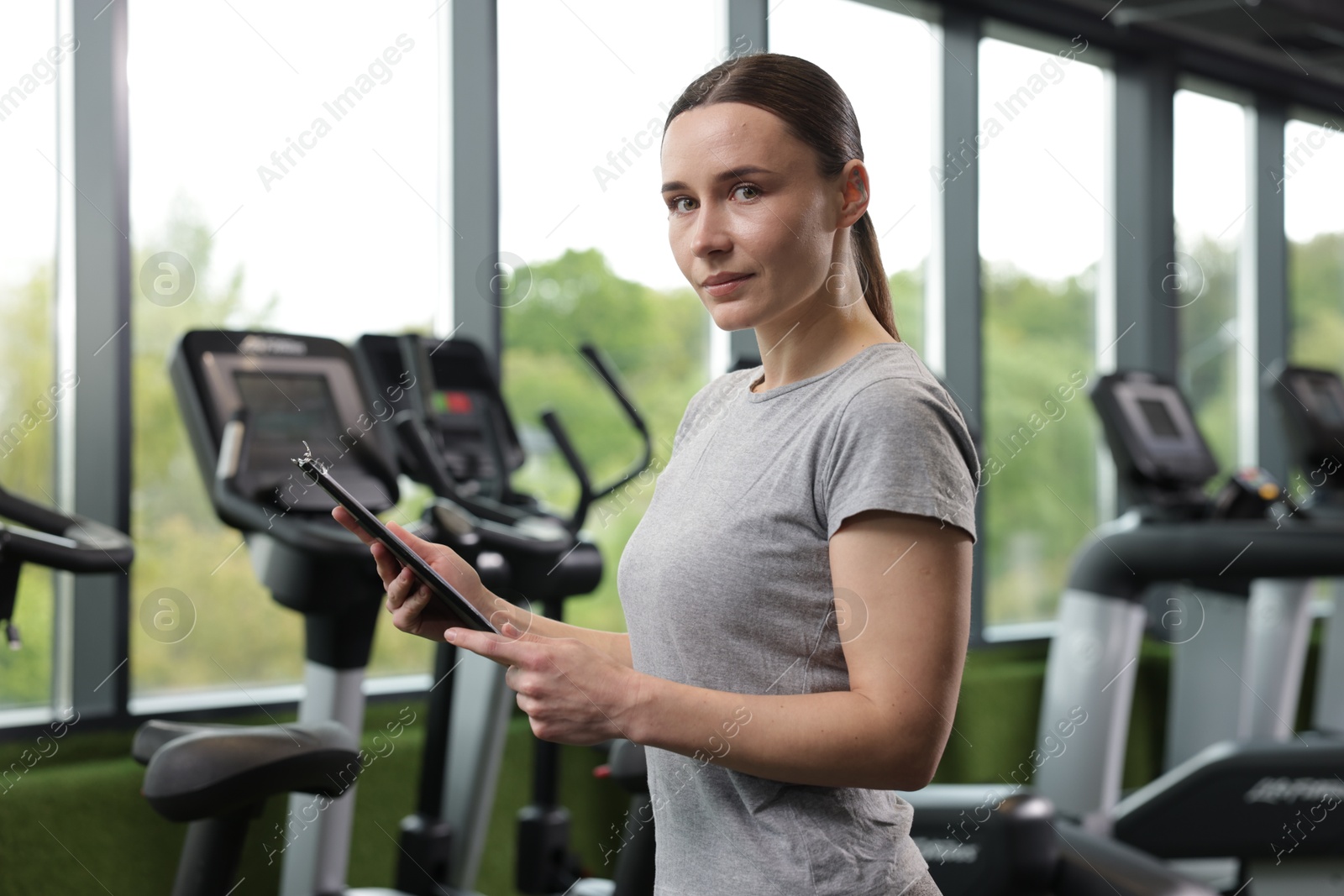 Photo of Professional personal trainer with clipboard in gym