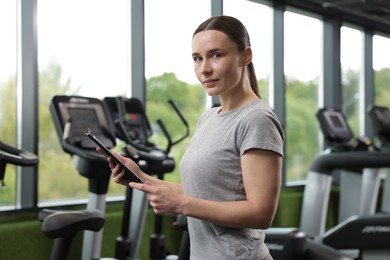 Photo of Professional personal trainer with clipboard in gym