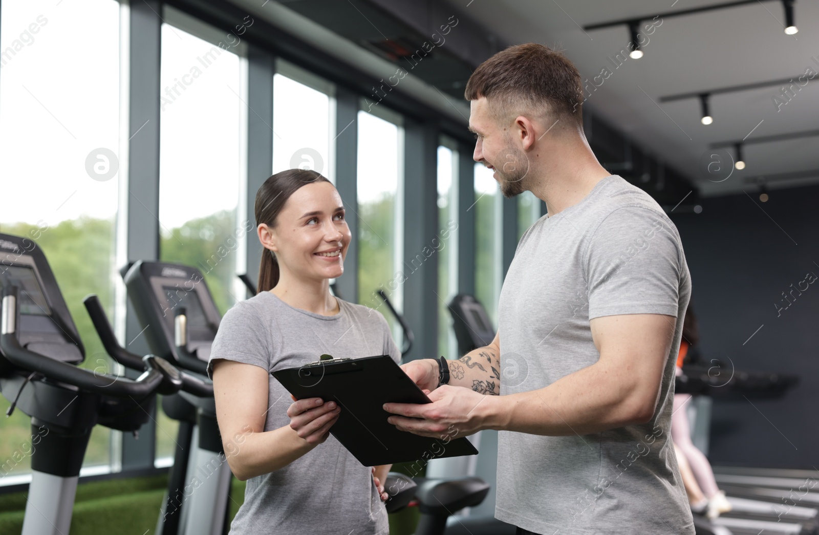 Photo of Professional personal trainers with clipboard in gym