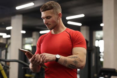 Photo of Personal trainer with tablet in sport center