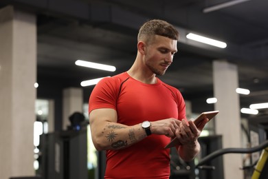 Photo of Personal trainer with tablet in sport center