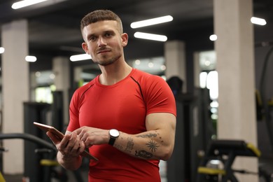 Photo of Personal trainer with tablet in sport center