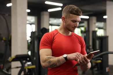 Photo of Personal trainer with tablet in sport center