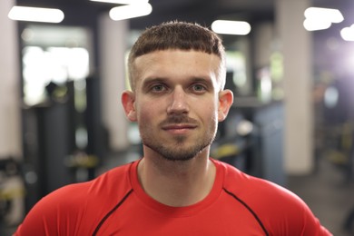 Photo of Portrait of professional personal trainer in gym