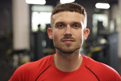 Photo of Portrait of professional personal trainer in gym