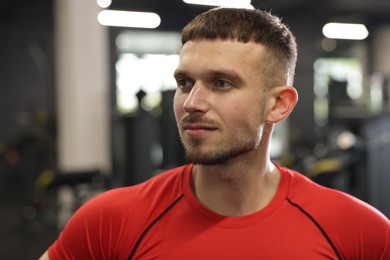 Photo of Portrait of professional personal trainer in gym