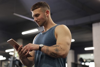 Photo of Personal trainer with tablet in sport center