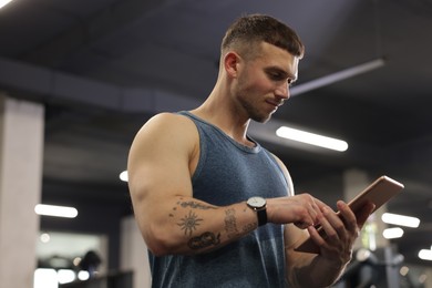 Photo of Personal trainer with tablet in sport center
