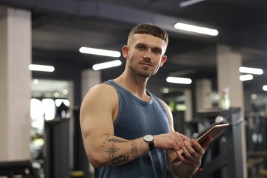 Photo of Personal trainer with tablet in sport center