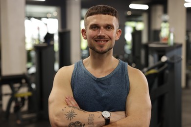 Photo of Portrait of professional personal trainer in gym