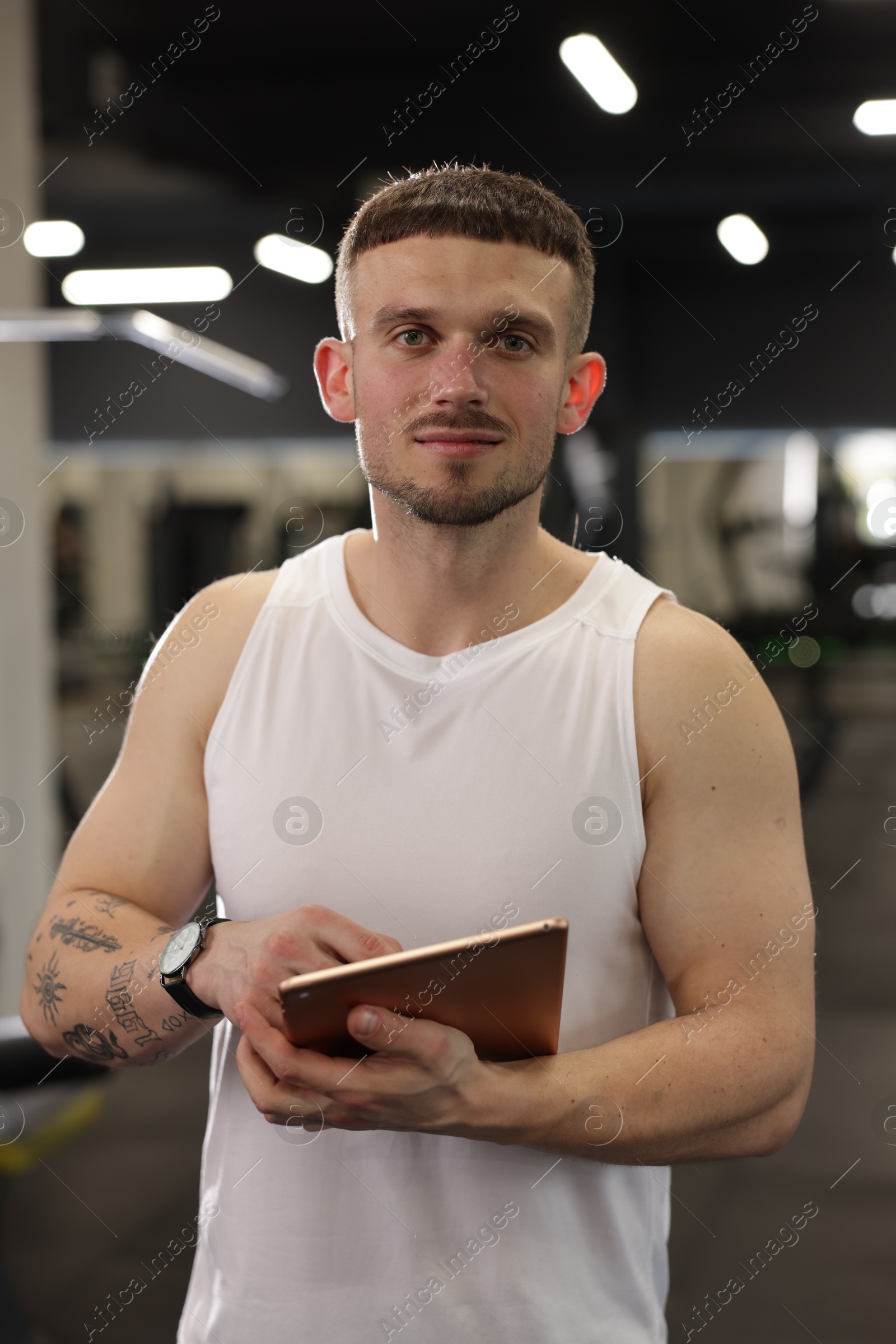 Personal trainer with tablet in sport center Photo of Personal trainer with tablet in sport center
