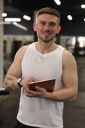 Photo of Personal trainer with tablet in sport center