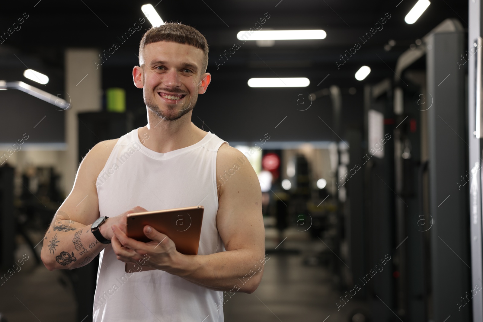 Personal trainer with tablet in sport center. Space for text Photo of Personal trainer with tablet in sport center. Space for text