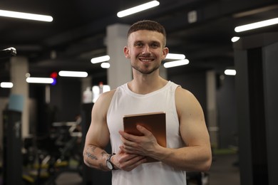 Photo of Personal trainer with tablet in sport center
