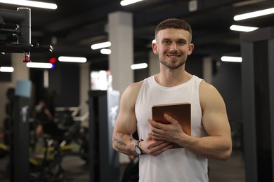 Photo of Personal trainer with tablet in sport center