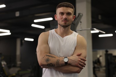 Photo of Portrait of professional personal trainer in gym