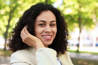 Photo of Portrait of smiling Latin American woman outdoors