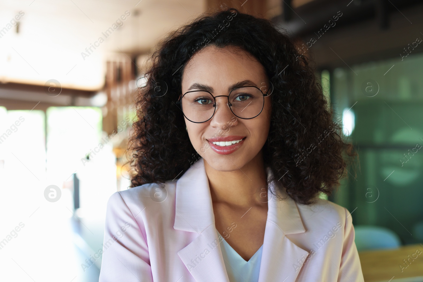 Photo of Portrait of smiling Latin American woman in cafe