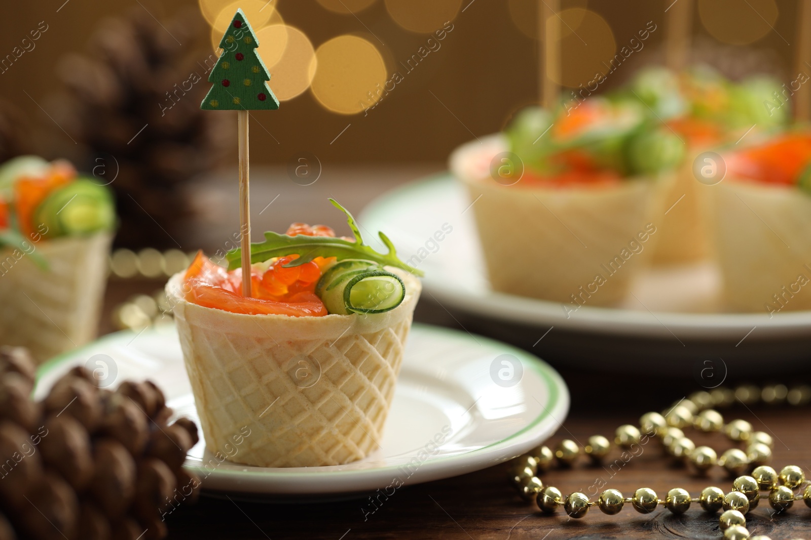 Tasty canapes and festive decor on wooden table against blurred lights, closeup. Bokeh effect Photo of Tasty canapes and festive decor on wooden table against blurred lights, closeup. Bokeh effect