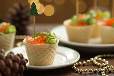 Photo of Tasty canapes and festive decor on wooden table against blurred lights, closeup. Bokeh effect