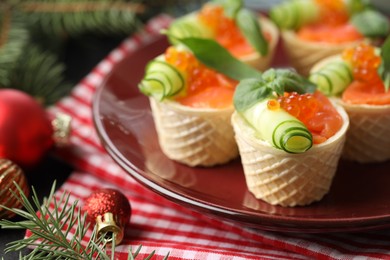 Photo of Tasty canapes and festive decor on table, closeup