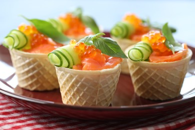 Photo of Tasty canapes with salmon and cucumber on table, closeup