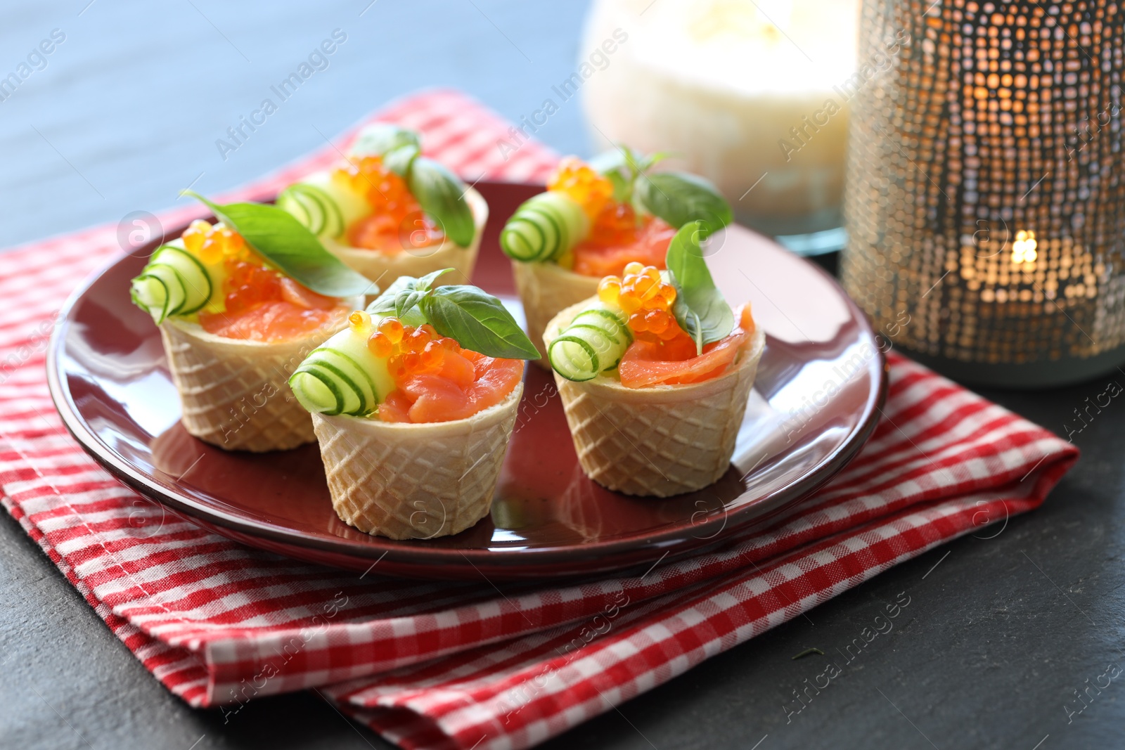 Photo of Tasty canapes with salmon on blue wooden table, closeup