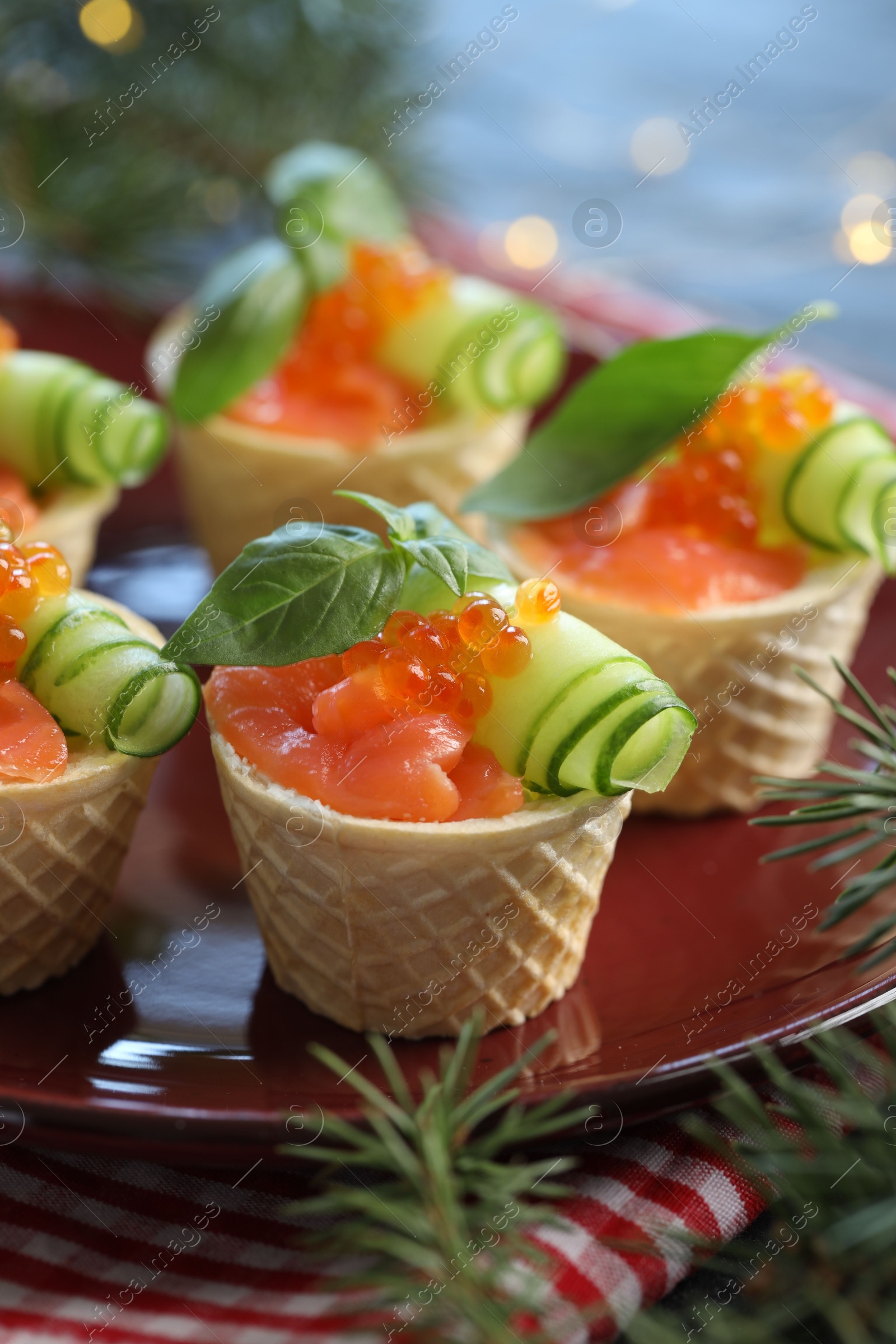 Photo of Tasty canapes and fir tree branches on table, closeup