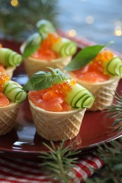 Photo of Tasty canapes and fir tree branches on table, closeup