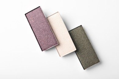 Photo of Beautiful eye shadow refill pans on white background, flat lay