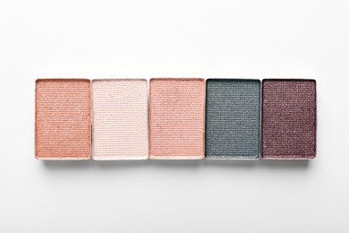 Photo of Beautiful eye shadow refill pans on white background, flat lay