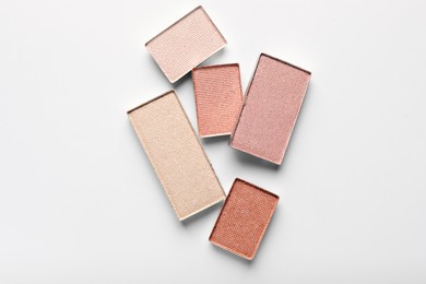 Photo of Beautiful eye shadow refill pans on white background, flat lay