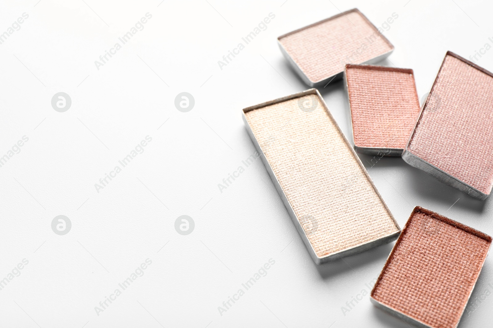 Photo of Beautiful eye shadow refill pans on white background, closeup. Space for text