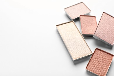 Photo of Beautiful eye shadow refill pans on white background, closeup. Space for text
